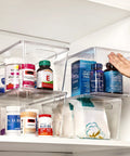Hella Nifty Clear Stackable Storage Bins With Secure Snap Lids And Comfortable Side Handles And Large 6 Pack Real Deal Option For Kitchen Pantry Closet Fridge Under Sink Bathroom Organization with vitamins on shelf.