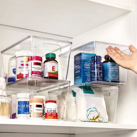 Hella Nifty Clear Stackable Storage Bins With Secure Snap Lids And Comfortable Side Handles And Large 6 Pack Real Deal Option For Kitchen Pantry Closet Fridge Under Sink Bathroom Organization with vitamins on shelf.