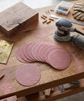 Super Cool 5 inch Mesh Sanding Discs With Hook And Loop Backing, 240 Grit Fine Aluminum Oxide For Wood and Metal Project Dust Free Set of 50 on a workbench.