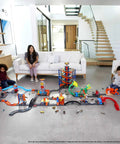 Children playing with BHT77 Diecast Car And Track Pack in Orange Includes Car And Track Pieces For Action Packed Play