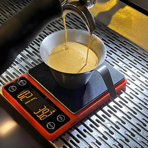 Compact Portable Coffee Scale With Timer 3kg 0.1g High Precision Espresso Scale in use with espresso cup on top, orange.