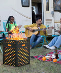 People enjoying a bonfire beside a camper with a Heavy Duty 63 Gallon Burn Barrel Fire Pit For Outdoors 30 Inch Incinerator Barrel