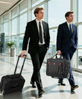 Black rolling luggage set side view: wheeled carry-on and rolling laptop bag with red accents.