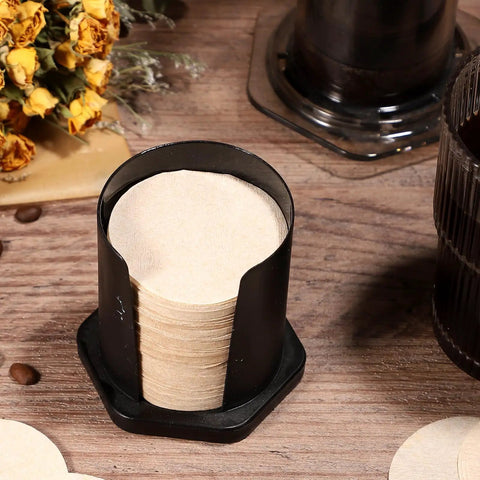Unbleached Round Disposable Coffee Filters, 600 Count, 64 Mm 2.5 Inch Size displayed in a holder on a wooden table