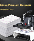 Stack of budget friendly sublimation paper 8.5x14 inches, 200 sheets with silicone paper beside heat press machine for light fabrics