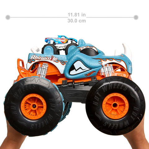 Monster Trucks RC Toy With Transforming Rhinomite, 1:12 Scale Monster Truck And 1:64 Scale Race Ace, held, showcasing size.