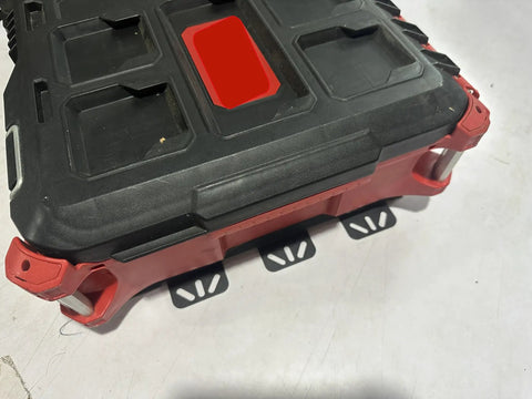 Close-up of a black and red toolbox mounted on a Packout Wall Mounting Plate For Milwaukee Toolboxes Sturdy Metal Base Mounting System