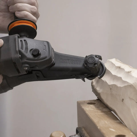 Close-up of No Nonsense Heavy Hitter 8 Amp Mini Wood Carving Router cutting detailed wood, featuring carbide blades for sculpting.