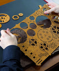 Person holding laser-cut pieces from Gear Globe Wall Clock Kit With 369 Laser Cut Pieces, DIY Wooden 3D Puzzle Clock That Builds Without Glue.