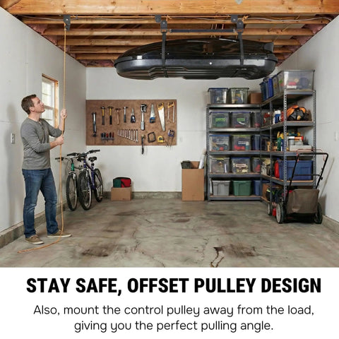 Man operating Garage Ceiling Cargo Hoist with metal pulley system, lifting rooftop carrier, in organized garage space.