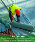 Worker installing Heavy Duty 15 Mil Concrete Vapor Barrier Plastic Sheeting, 7 Ft By 70 Ft Roll, Blue Polyolefin Tarp at site