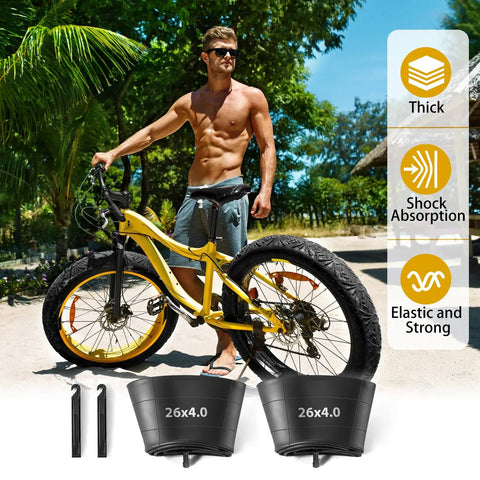 2 Pack 26 x 4.0 Fat Tire Inner Tube With 32mm Schrader Valve Puncture Resistant Butyl Rubber Tubes For Fat Bike Mountain Bike And EBike Easy Install With Included Tire Levers displayed with fat bike and beach background.