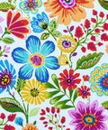 Colorful floral pattern with various vibrant flowers and green leaves on a white background.