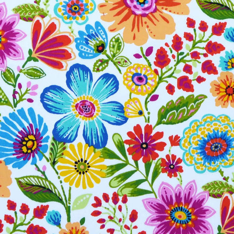 Colorful floral pattern with various vibrant flowers and green leaves on a white background.
