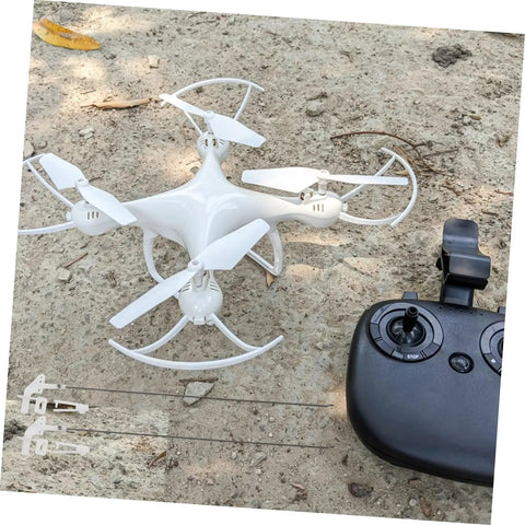 20 Pack Heavy Duty Metal RC Airplane Linkage Stoppers Plus Adjustable Push Rod Connectors For Fixed Wing Models Quick Swaps DIY Mods Rock Solid Flyin Gear on sandy ground next to a remote control.