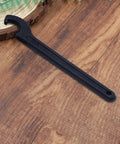 Heavy Duty C Hook Spanner Wrench In Matte Black crafted from tough as nails carbon steel for 22 to 26 mm round nuts on wood surface.