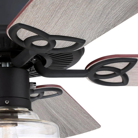 Close-up of matte black hardware and reversible weathered oak blades on a Vintage Style LED Ceiling Fan With Light, 52 Inch Matte Black Ceiling Fan With Clear Glass Schoolhouse Shade, Reversible Weathered Oak And Walnut Blades, Large Room Ready Up To 225 Sq Ft, Combo Mount.