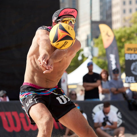 Player hosting AVP OPTX Game Volleyball Official Size Yellow Black For Beach Play Durable Official Volleyball Construction With Enhanced Grip And Vivid Visual Design Great For Training Refs And Competitive Sand Sessions during match
