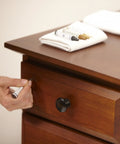 Applying Wax Wood Furniture Filler Sticks Scratch Repair Kit With 5 Color Blends And Sharpener on wooden drawer.