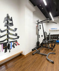 Make Your Garage Gym Setup Look Dope With These Hella Solid Lat Pulldown Bar Storage Hooks Designed To Hold Heavy Weights And Keep Your Workout Zone Totally Tidy, featuring a wall-mounted organizer with resistance bands.