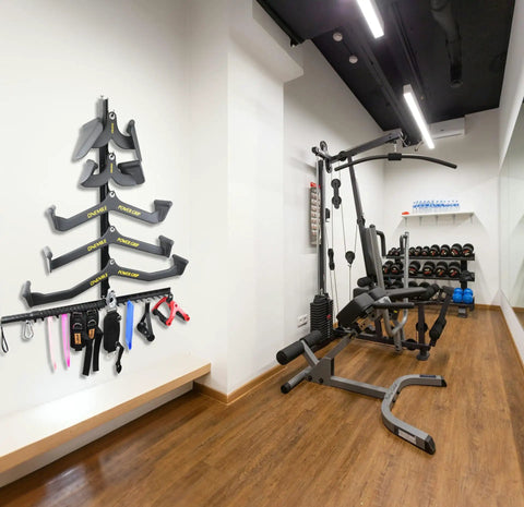 Make Your Garage Gym Setup Look Dope With These Hella Solid Lat Pulldown Bar Storage Hooks Designed To Hold Heavy Weights And Keep Your Workout Zone Totally Tidy, featuring a wall-mounted organizer with resistance bands.