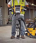 Worker using Heavy Duty Large Hammer Dust Extraction Attachment For Demolition Hammers With Universal Fit for pavement breaking.