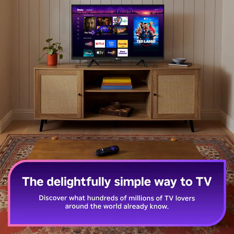Next Level HD Media Stick Player With Clutch Voice Remote; TV setup showcasing streaming apps and remote on a coffee table.