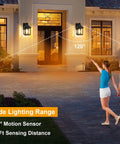 Rock Solid Outdoor Solar Sconce Lights Featuring Integrated Panels For Instant Front Porch Glow And Zero Wiring Hassle Free Weather Resistant Wall Mount Fixtures Straight Up Reliable Dust To Dawn illuminating a front porch with a couple walking.
