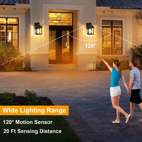 Rock Solid Outdoor Solar Sconce Lights Featuring Integrated Panels For Instant Front Porch Glow And Zero Wiring Hassle Free Weather Resistant Wall Mount Fixtures Straight Up Reliable Dust To Dawn illuminating a front porch with a couple walking.