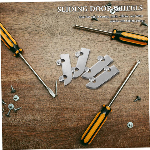 Heavy Duty Stainless Steel Sliding Door Bottom Wheel Set 4 Piece Track Rollers lying on a wooden surface next to screwdrivers and screws.