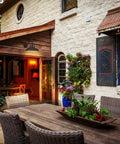 Outdoor patio with wicker furniture and a Gooseneck Barn Light With Dusk To Dawn Sensor Outdoor Wall Sconce Vintage Farmhouse Vibe