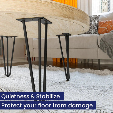 Close-up of 16-inch hairpin table legs, three rods, black steel supporting a wooden tabletop with rubber floor protectors.
