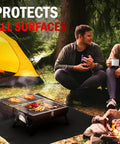 People sitting around a campfire with a grill on a Carbon Fiber Welding Blanket Heat Shield 1800F Fireproof 20-Inch By 20-Inch mat