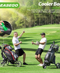 Golfers enjoying drinks next to All Terrain 3 Wheel Golf Push Cart With Foldable Design and cooler bag on green course.