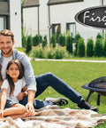 Family in garden with Portable Folding Fire Pit 29 Inch Round Steel Fire Bowl With Folding Legs Wood And Cookout Grate