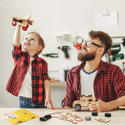 Child playing with model plane, parent assisting with 5 In 1 STEM Kit For Kids Ages 8 To 12 Build Five Model Cars Wooden 3D Puzzles.