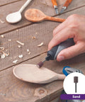 Side view of Dremel Stylo+ craft rotary tool with sanding bit shaping a wooden spoon