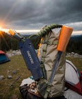 Ferro Rod Survival Kit With Flint And Steel Fire Starter And Whistle attached to a camping backpack in the mountains at sunrise.
