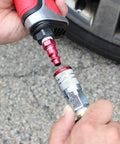 Red M-Style Pneumatic Plugs 1/4 Inch NPT Male being connected to a coupler, showing the fitting process for air systems.