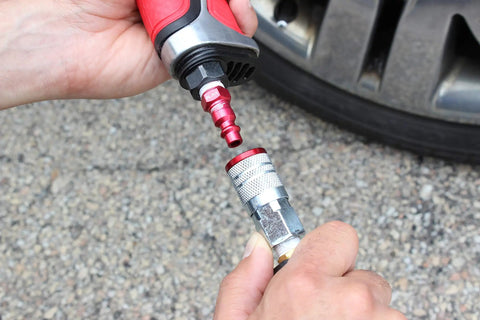 Red M-Style Pneumatic Plugs 1/4 Inch NPT Male being connected to a coupler, showing the fitting process for air systems.