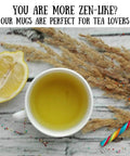 Top view of a lemon slice, tea in a white mug, candy cane, and dried grass on a wooden surface with tea lover text above.