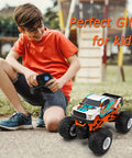 Child playing with One Sixteen Scale RC Monster Truck For All Terrain 2.4GHz Dope Off Road Vehicle With Up To 20 Km Per Hour Speed.