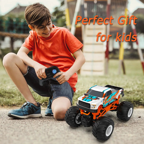Child playing with One Sixteen Scale RC Monster Truck For All Terrain 2.4GHz Dope Off Road Vehicle With Up To 20 Km Per Hour Speed.