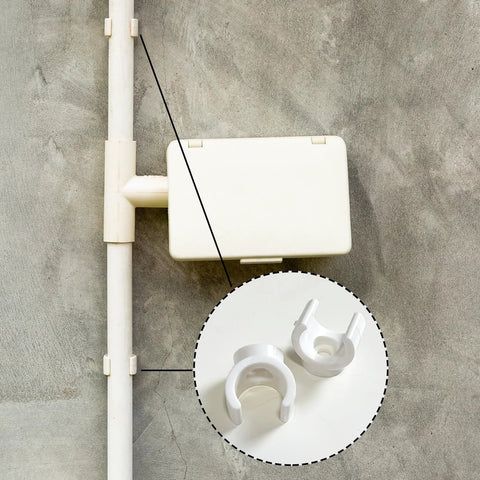 Two white plastic PEX pipe clamps for 1/2 in tubing; shown with PVC pipe and enclosure.