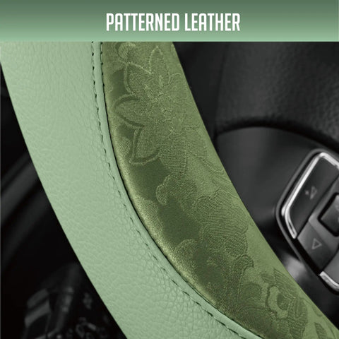 Close-up of green patterned PU leather steering wheel cover showcasing anti-slip grip, designed for modern cars.