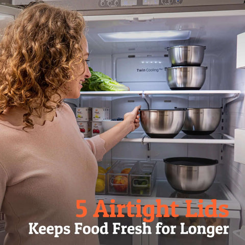 Woman placing Stainless Steel Mixing Bowls with Lids Set featuring airtight lids and non-slip base into fridge, five nesting bowls shown.
