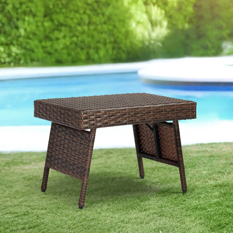 Portable Folding Wicker Table With Steel Frame For Outdoor Use next to pool on grass