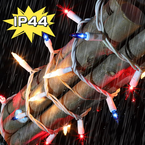Patriotic String Lights Kit With Red White Blue Mini Lights On White Wire, 19.6 Feet, 100 Count wrapped around tree in rain