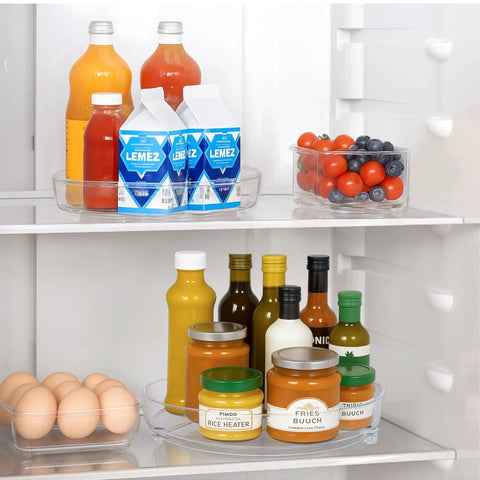 Two Pack Nine Inch Clear Acrylic Lazy Susan Turntable Spinner With Non Slip Base For Kitchen Pantry Cabinet Fridge And Makeup Tray That Is A Straight Up Game Changer For Decluttering Your Home Hella Sturdy holding various drinks and food items in a refrigerator.