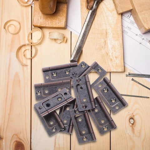 Top-down view of 10-pack stainless steel cabinet hinges on a wooden work surface.